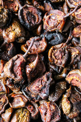 Vertical shot of dark brown dried pears. Dry pears. Fruit.