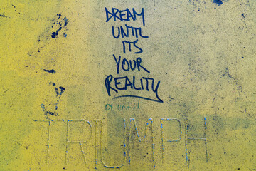 graffiti message written on metal street slab