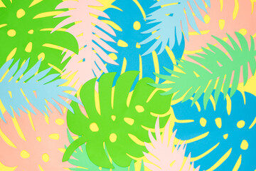 Paper cut tropical leaves. Pattern from multi-colored monstera and palm leaves. Summer rainforest...