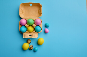 Colorful easter eggs in box on blue background