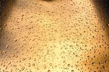 Many different drops of water on the metal surface