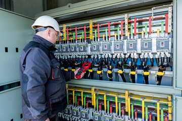 Checking the operating voltage levels of the solar panel switchgear compartment