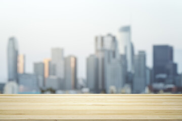 Blank table top made of wooden planks with beautiful blurry cityscape at daytime on background, mockup