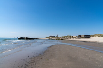 old bunkers on the beaches at Skagen in north Denmark with the lighthouse in the background