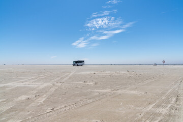 large RV parked on an endless golden sandy beach on the Wadden Sea islands of western Denmark