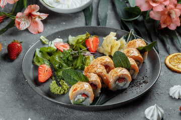 Maki Sushi - a roll of cream cheese, strawberries, avocado and fried salmon. Summer seasonal sushi rolls