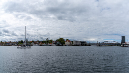 Fototapeta na wymiar sailboat cruising into the harbor of downtown Sonderborg