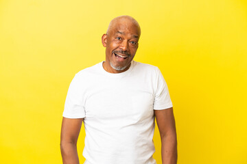 Cuban Senior isolated on yellow background with surprise facial expression