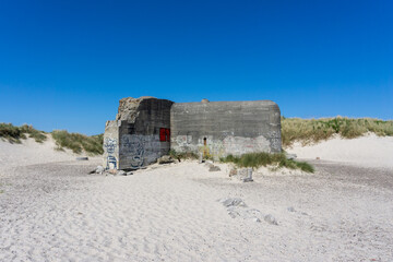 close up view of an old bunker on the beaches at Skagen in northern Denmark under a blue sky