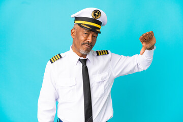Airplane pilot senior man isolated on blue background showing thumb down with negative expression