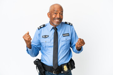 Young police man isolated on white background celebrating a victory in winner position