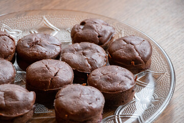 Homemade delicious chocolate muffin on wooden background close-up
