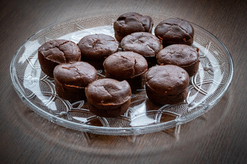 Homemade delicious chocolate muffin on wooden background close-up