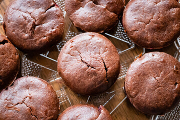 Homemade delicious chocolate muffin on wooden background close-up