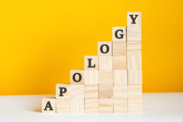 the word apology is written on a wooden cubes, concept - obrazy, fototapety, plakaty