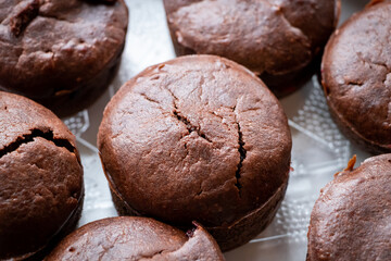 Homemade delicious chocolate muffin on wooden background close-up