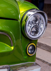 Retro car festival. Retro car headlight. Fragment of the front of a retro car.