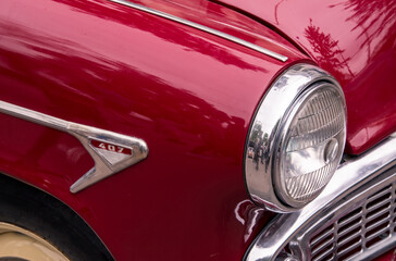 Retro car festival. Retro car headlight. Fragment of the front of a retro car.