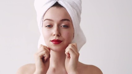 Face yoga. Skin treatment. Maintain contours massage. Facelift training. Relaxed woman in white towel enjoying doing facial fitness exercise with fingers isolated on light.