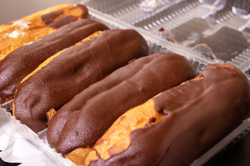 Chocolate custard cakes in plastik box closeup