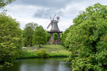 view of the historic Am Wall windmill in the old moat and city park of Bremen - obrazy, fototapety, plakaty