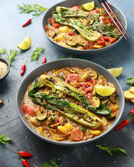 Asian style Pak choi, lemongrass, and ginger curried noodles served with lime wedges