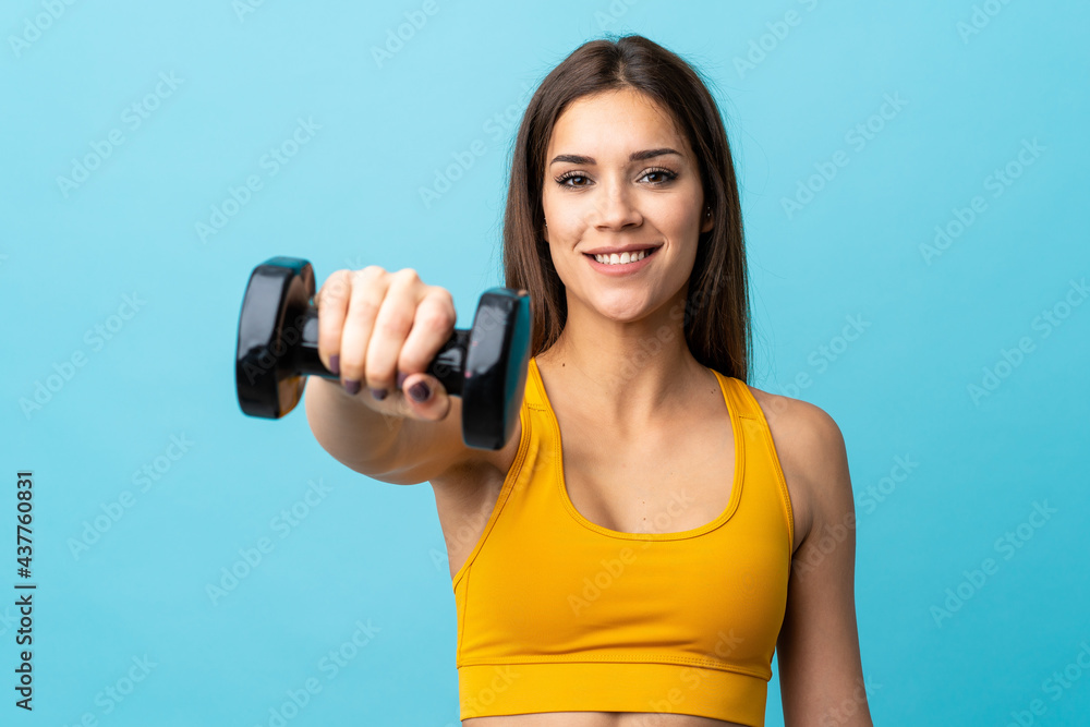 Sticker Young caucasian woman making weightlifting isolated on blue background