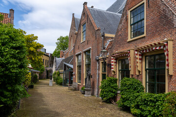 picturesque neighborhood street with red brick buildings in the historic city center of Haarlem