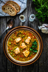 Fish soup on wooden table
