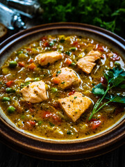 Fish soup on wooden table
