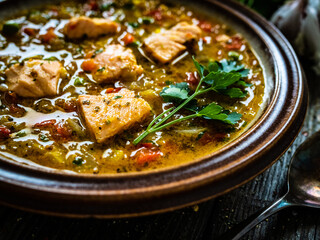 Fish soup on wooden table
