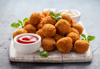 Meat free vegetarian mini picnic scotch eggs with micoprotein and herbs served with ketchup and mayonnaise