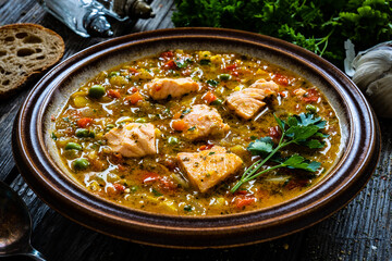 Fish soup on wooden table
