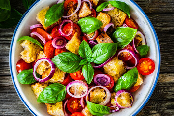 Classic panzanella salad on wooden board
