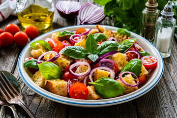 Classic panzanella salad on wooden board

