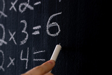 A close up of equations on a chalkboard.