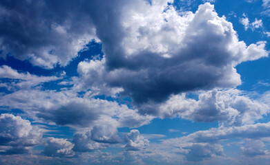 Beautiful contrasting large clouds in blue sky for background