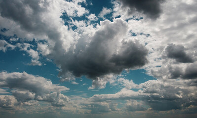 Beautiful contrasting large clouds in blue sky for background