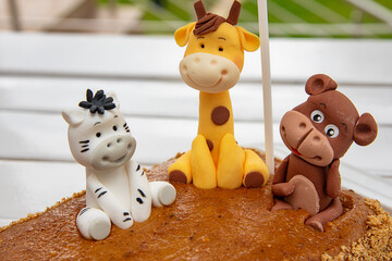 Children's birthday cake with giraffe, monkey and zebra
