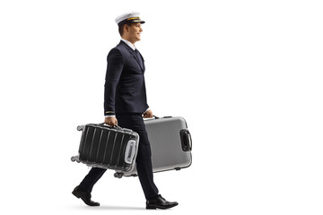 Full length profile shot of a pilot walking and carrying suitcases