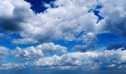 Beautiful contrasting large clouds in blue sky for background
