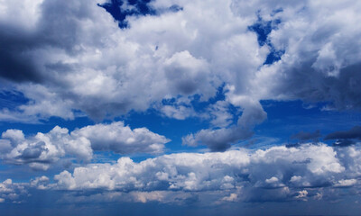 Beautiful contrasting large clouds in blue sky for background