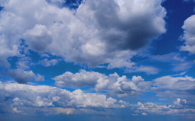 Beautiful contrasting large clouds in blue sky for background