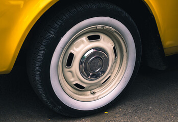 Retro car festival. Tire of an old retro car. Fragment of the front of a retro car.