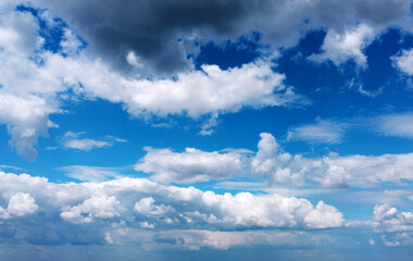 Obraz premium Beautiful contrasting large clouds in blue sky for background