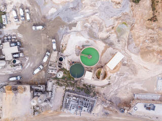 Fototapeta na wymiar Quarry stone. Mining and processing plant, mineral piles and sand Industrial building.