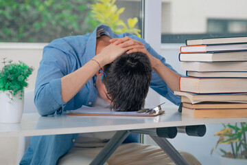 student at desk with stressed or overwhelmed books