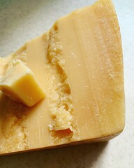 a piece of ripening cheese, a piece of grana padano, long-ripening cheese, milk products, natural...