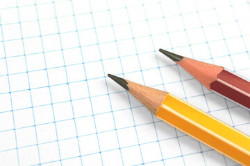 Lead pencils on a checkered notebook page background, education concept, copy space photo