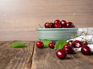 ripe cherries on an old wooden rustic table with place for text